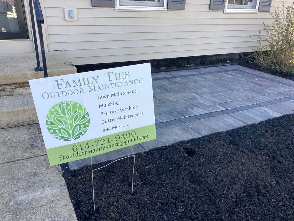 Sign for Family Ties Outdoor Maintenance, offering lawn care, pressure washing, and more.